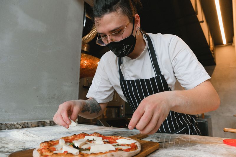 Marcos team crafting fresh marco pizza with quality ingredients